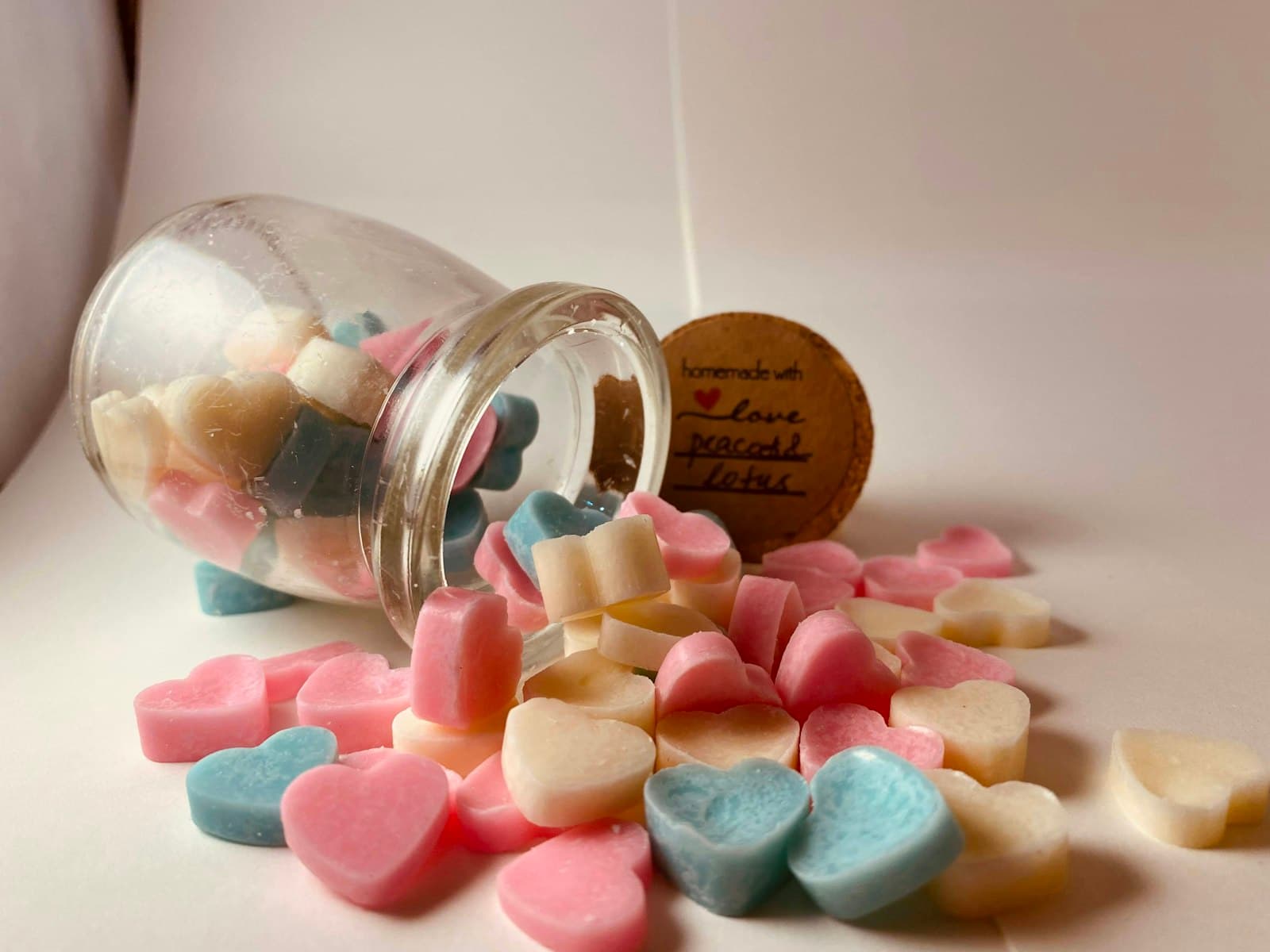 A glass jar filled with small candy hearts.